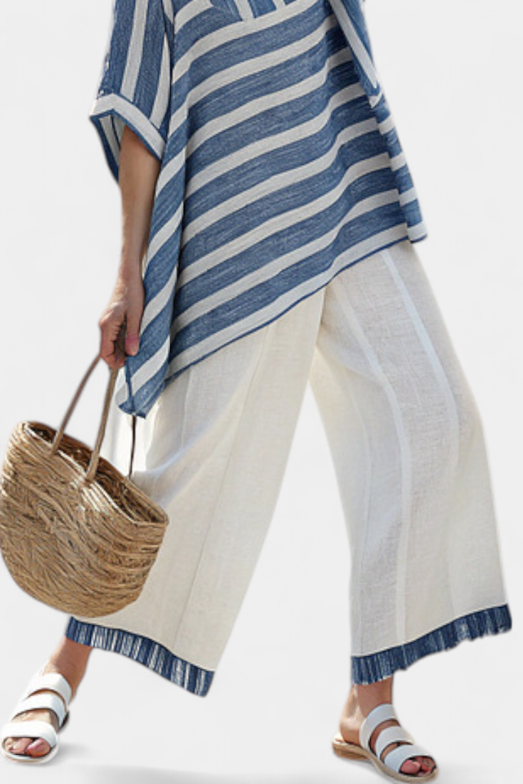 Elegant linen set in Mediterranean style with blue stripes and finished-bottom trousers for a fresh and stylish look