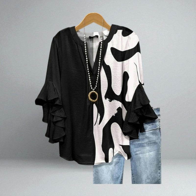 Colette – Black and white graphic blouse with ruffled sleeves